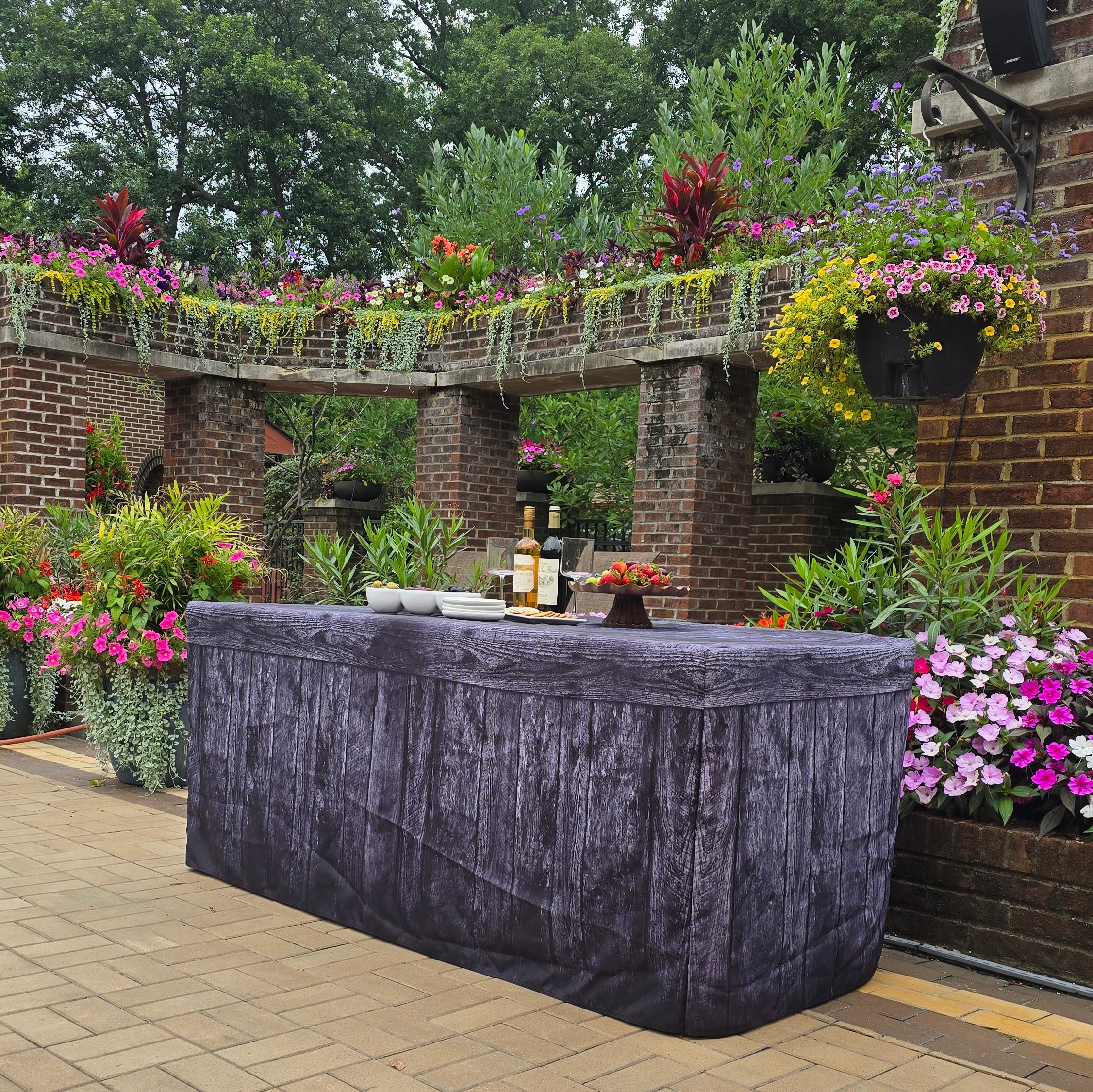 Black Wood Fabric Fitted Table Covers that  look like wood to cover folding tables at events.