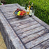 A rectangle 6FT folding table with a fabric fitted able cover with a rustic reclaimed wood look and rivets on the side. It looks like a true old pirate ship or bourbon barrel decor.