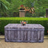 A medium size 6ft folding table covered with a gorgeous fabric fitted table cover that looks like old wood with metal rivets. Sitting outside by a pool for an outdoor event.