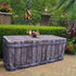 Outdoor special event or party decorated with a 6ft fabric table cover that looks like old reclaimed wood with metal rivets along the side of the table cover. 