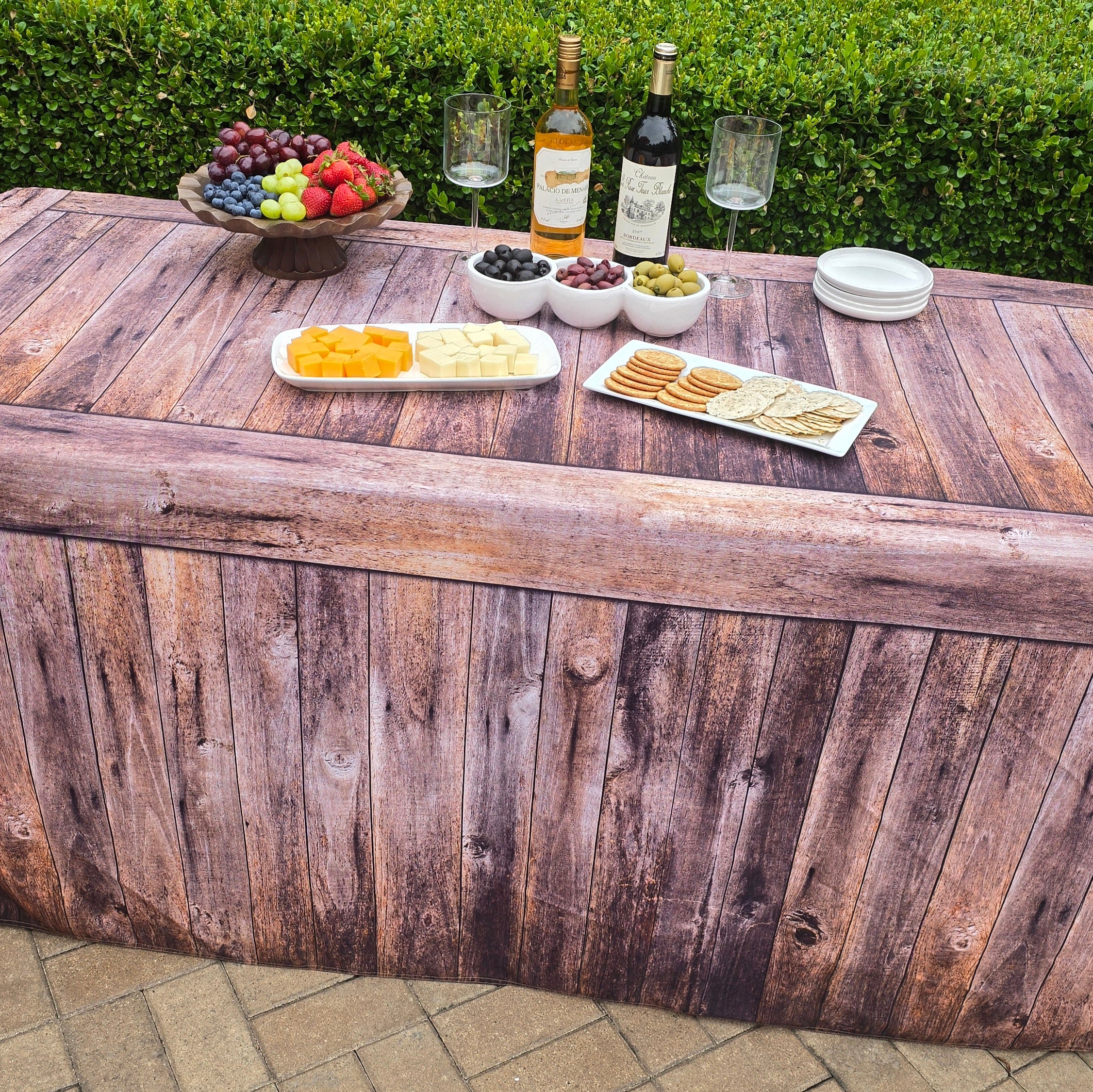 Rustic Wood Fabric Fitted Table Cover that looks like real wood used at a resort outdoor pool party.