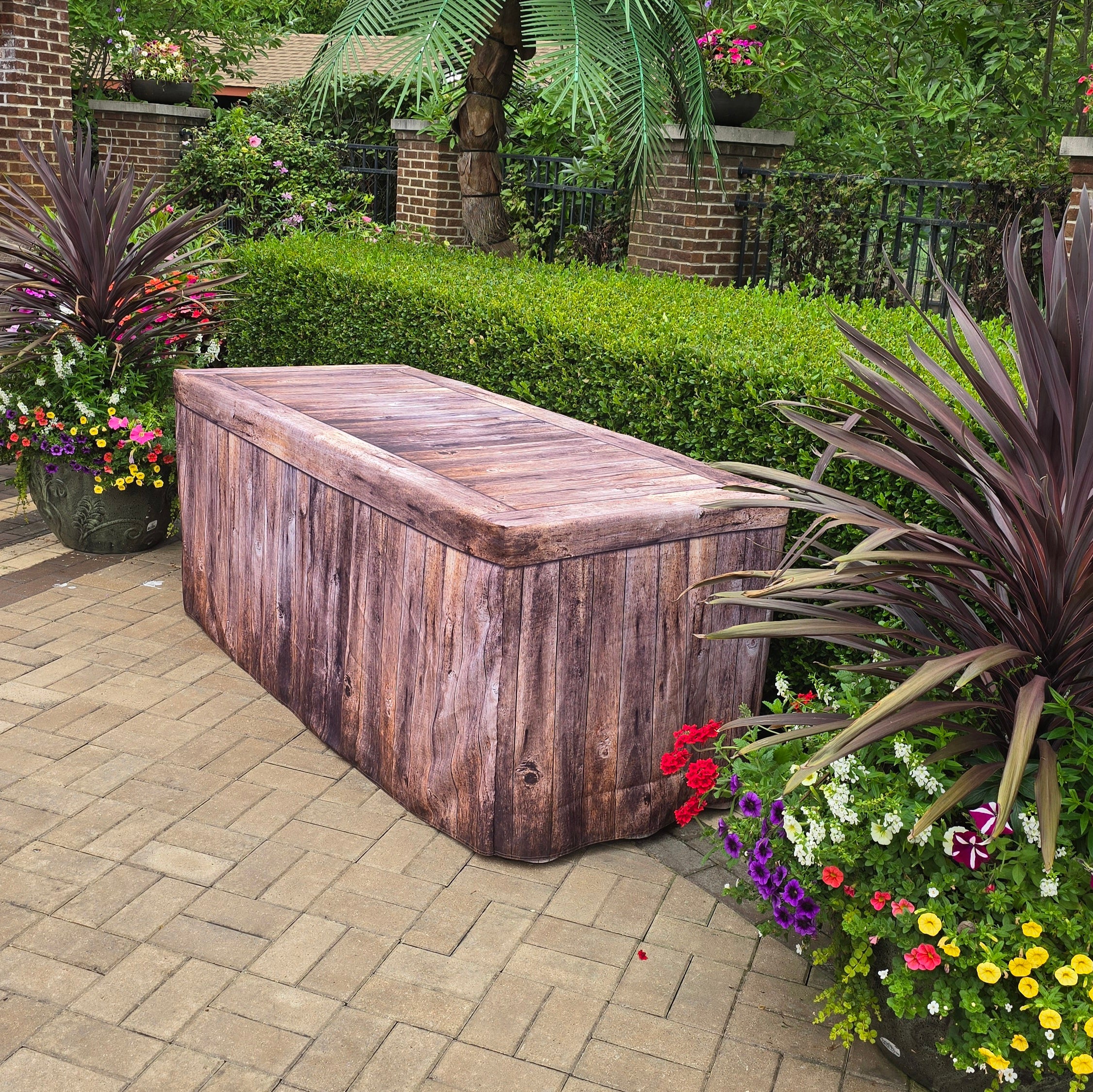 Rustic Wood Fabric Fitted Table Cover over a plastic folding table at a resort used for outdoor parties and events.