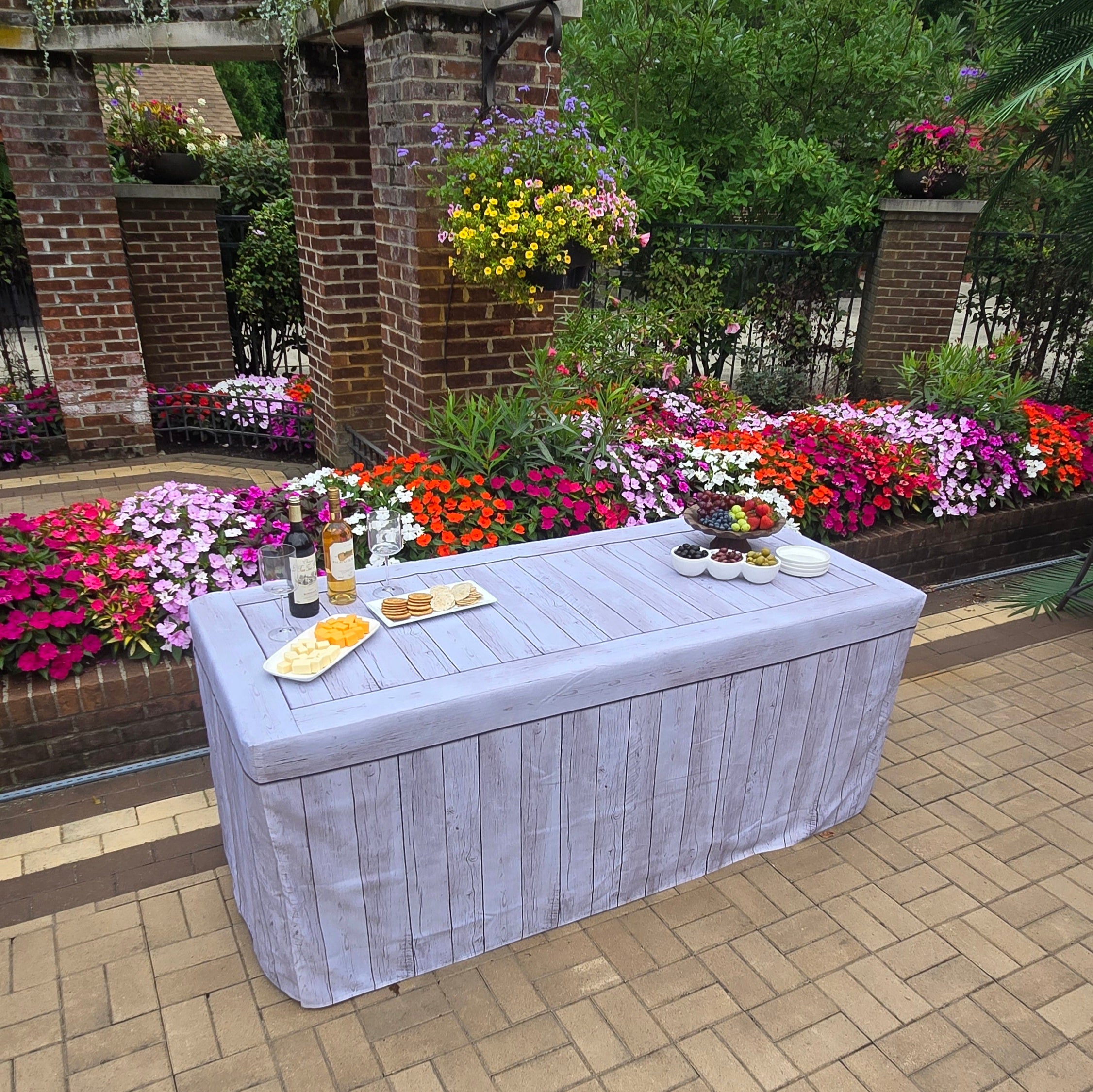 Rectangle 6FT folding table covered with a rustic faux wood fabric table cover that looks like real wood at an outdoor wedding.