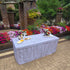 Rectangle 6FT folding table covered with a rustic faux wood fabric table cover that looks like real wood at an outdoor wedding.